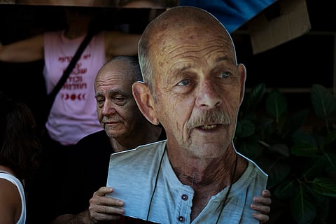 Israel-Hamas war: A relative holds a cardboard cut-out of Haim Peri